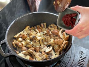 tomatenmark zu zwiebeln und champignons geben