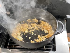 zwiebeln und knoblauch in pfanne anduensten